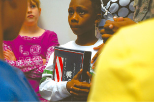 Soldier presents flag to Meadows Elementary